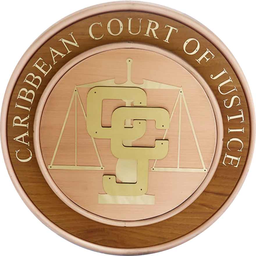 The Seal of the Caribbean Court of Justice — the CCJ monogram over the scales of justice, crafted in brass and teak
